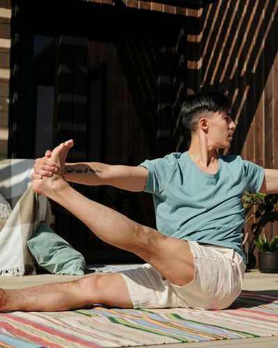 A person holding a challenging balance pose on one leg.