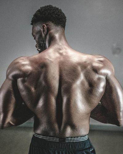 Muscular back of a man during a powerful movement.